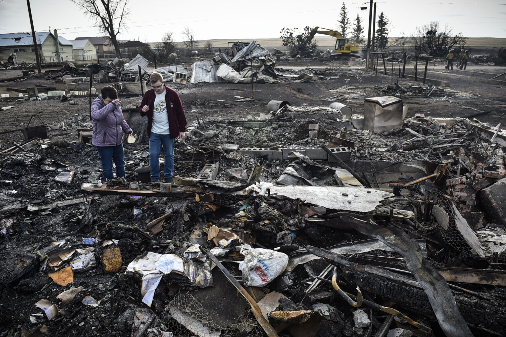 Summer Allen and her son dig through the remains